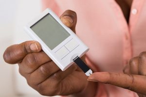 Close-up Of Hand Holding Device For Measuring Blood Sugar